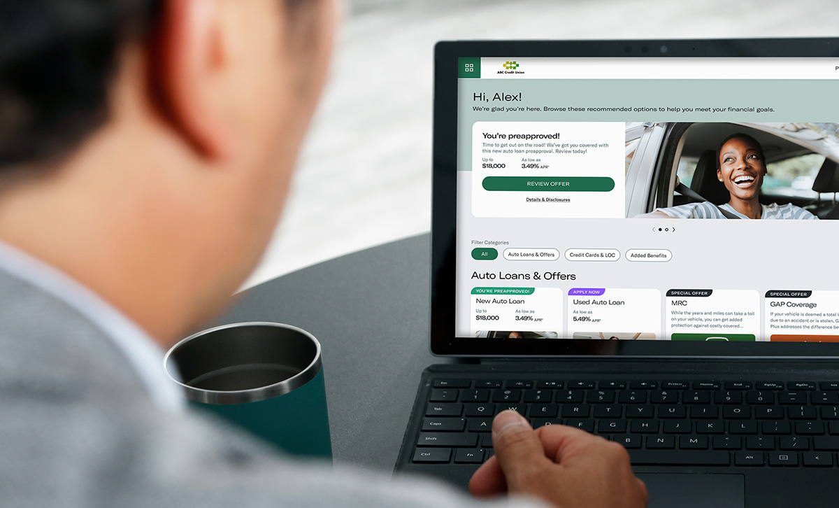 A man using a laptop reviews personalized offers made available through the Digital Storefront.